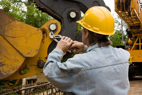 Mechanic using a wrench to repair a car engine, representing reliable auto repair services.