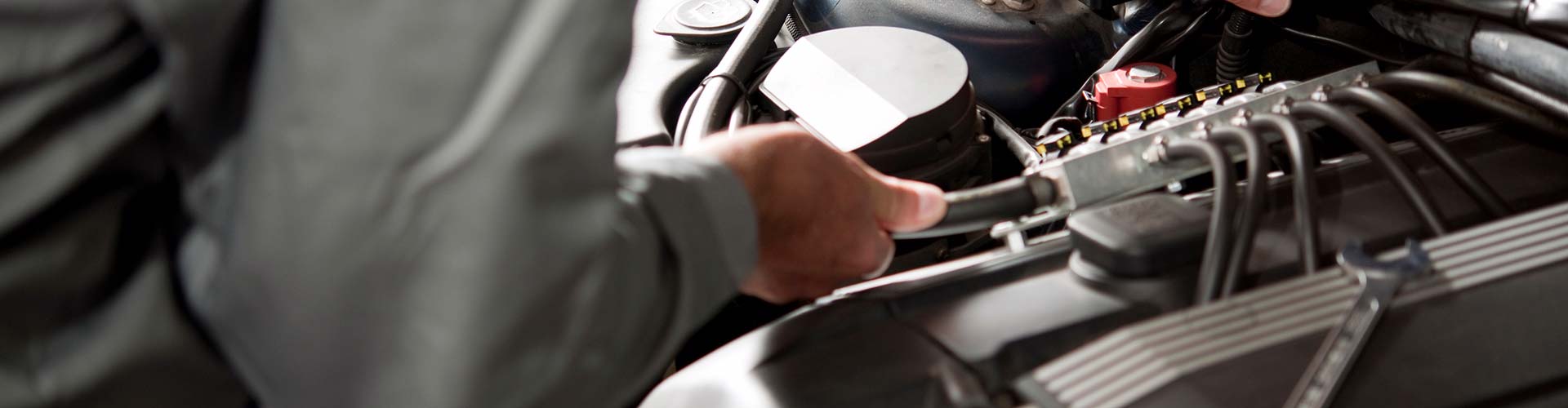 Mechanic performing a vehicle inspection with a clipboard, showcasing thorough automotive service.