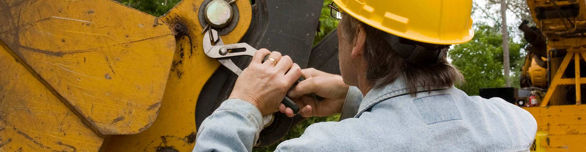 Mechanic performing a vehicle inspection with a clipboard, showcasing thorough automotive service.